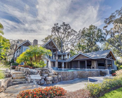 Orlando backyard privacy landscaping by BLG Environmental Services with mature shade trees, natural screening plants, and luxury hardscape design.