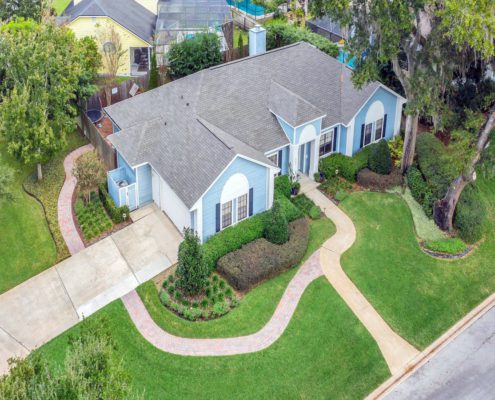 Sustainable landscape design in Orlando with climate-adapted plants, drainage planning, and outdoor living elements.