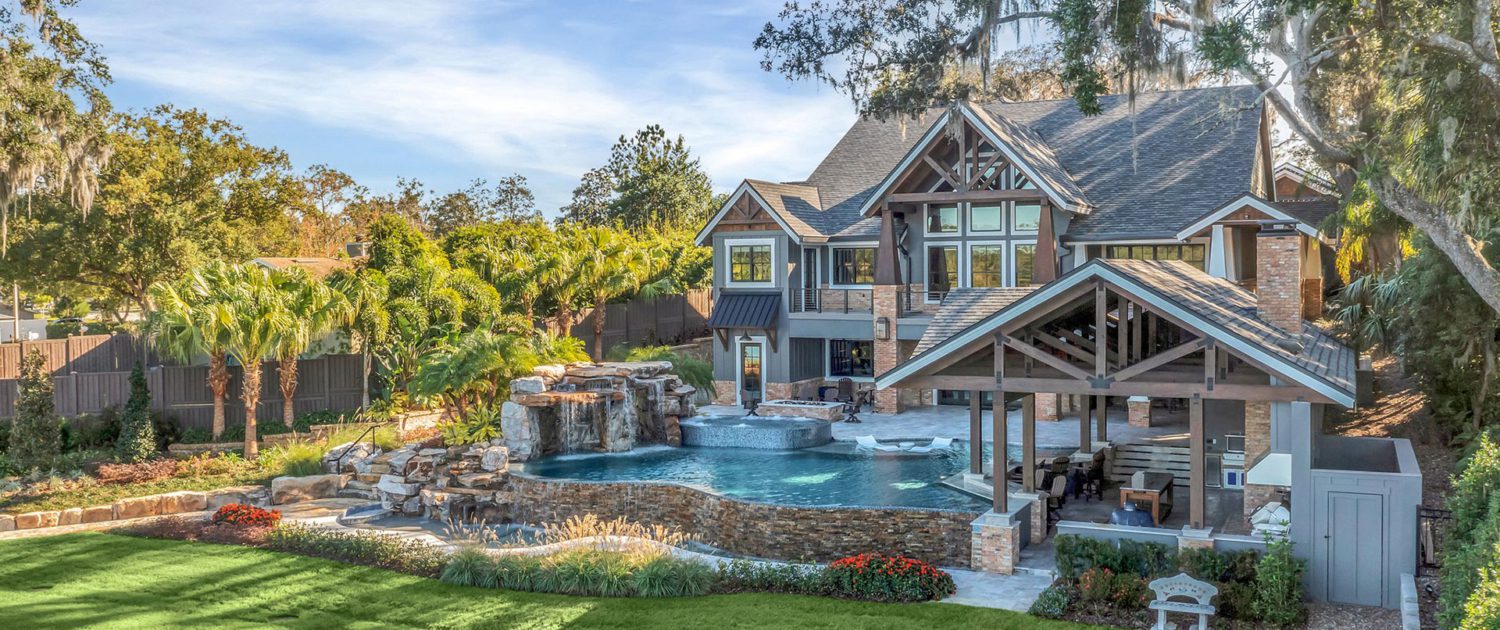 Estate landscape enhancement featuring integrated pool, outdoor living spaces, mature landscaping, and cohesive residential property design in Orlando, Florida