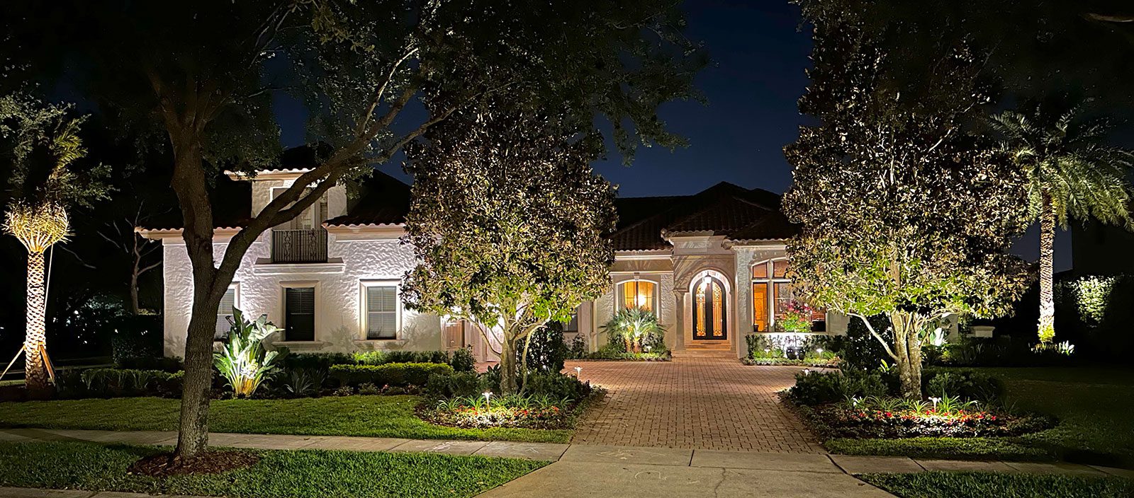 Estate landscape enhancement featuring integrated pool design, outdoor living spaces, mature landscaping, hardscape elements, and cohesive residential property design in Orlando Florida