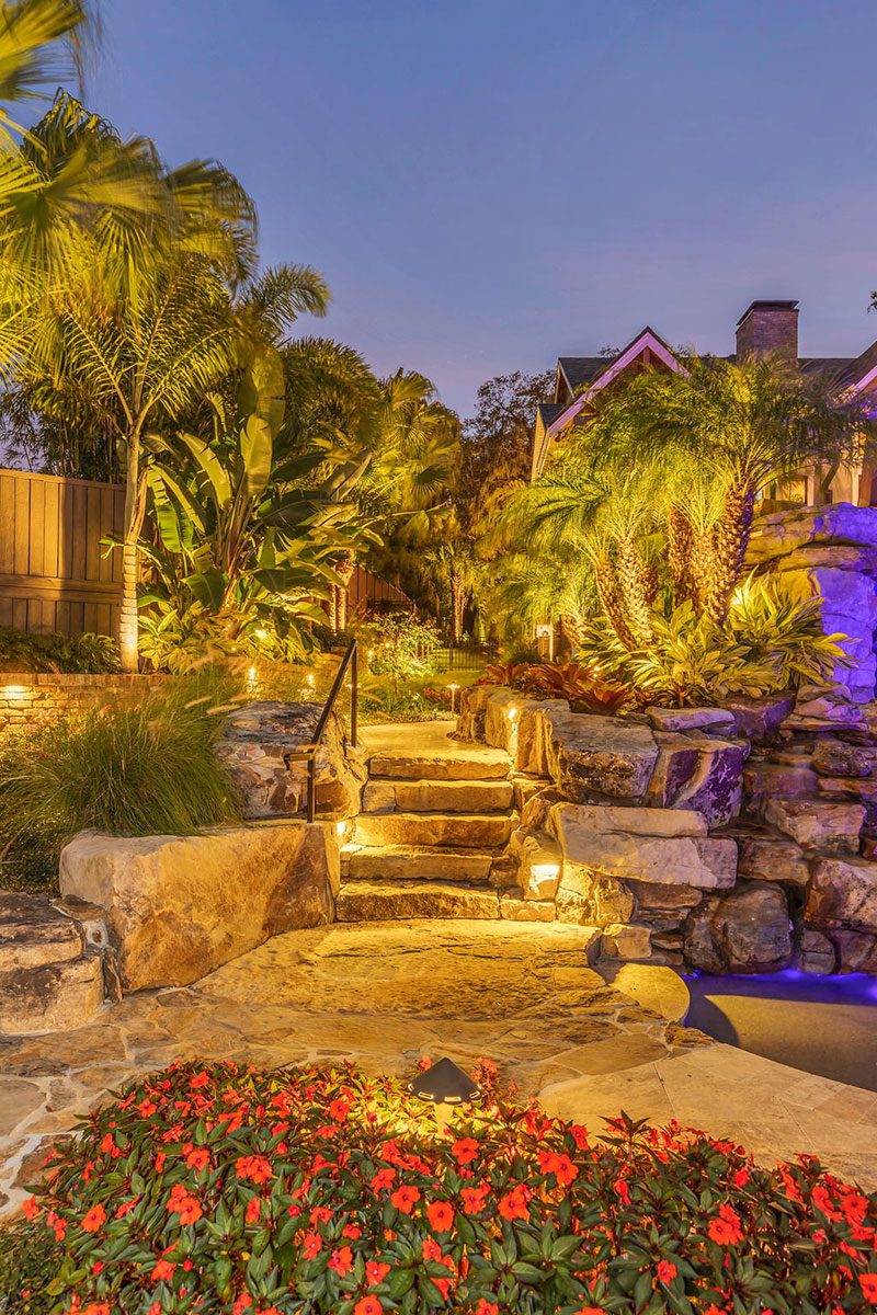 Estate landscape enhancement showcasing outdoor ambience, landscape lighting, mature landscaping, and cohesive property design